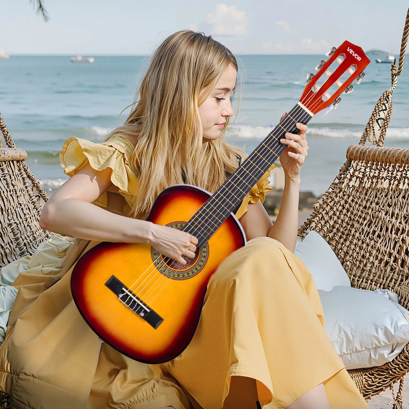 VEVOR 780 mm klasiskā basskoka ģitāra ar neilona stīgām, pilns iesācēju komplekts ar somu, siksnu, skaņotāju, stīgām, mediatoriem un kapo, saulrieta tonis